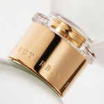 Detail of the top of the 100 ml bottle, with transparent glass and yellowish perfum. Spherical cap with gold band. Kingston Osmanthus, a fragrance by Eric Butherbaugh.