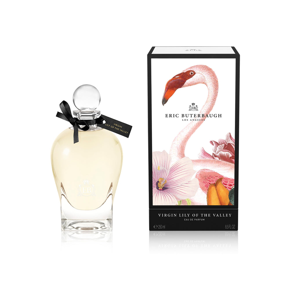 250 ml bottle, with transparent glass and yellowish perfum. Spherical cap with black ribbon. By his side the box, with pink flamingo and flowers illustration, within a black border. Virgin Lily of the Valley, a fragrance by Eric Butherbaugh.