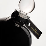 Detail of the top of the 250 ml bottle, with black opaque glass. Spherical cap with black ribbon. Oud Orange Flower, a fragrance by Eric Butherbaugh.