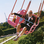 Eric Buterbaugh having fun in a pink cabin of a flying chairs atraction in Paris.